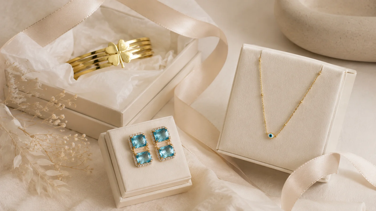 Zeray necklace, earrings and bangle arranged in elegant gift packaging